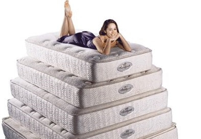 Stacked Mattresses, with lady lying on top